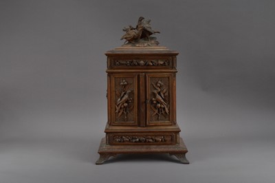 Lot 547 - A 20th century black forest carved wooden jewellery cabinet