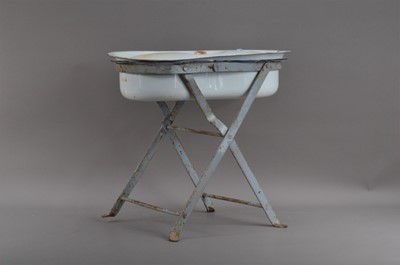 Lot 560 - An early 20th century enamel bidet and cover on a metal stand