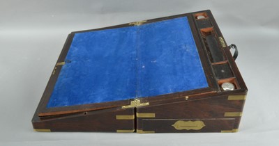 Lot 215 - A 19th century rosewood veneered and brass bounded campaign writing slope