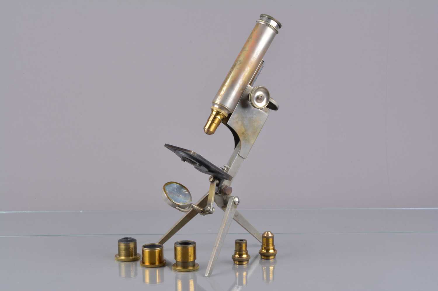 Lot 16 - An early 20th Century nickel-plate brass R & J Beck Folding Portable Compound Monocular Microscope