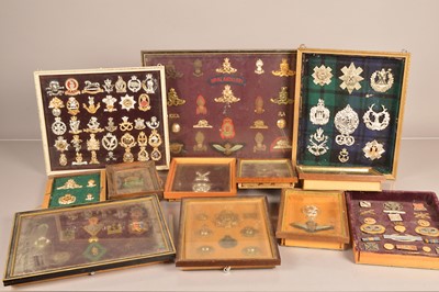 Lot 572 - A collection of framed and glazed cap badges