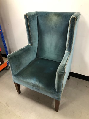 Lot 35 - A velvet upholstered wingback armchair