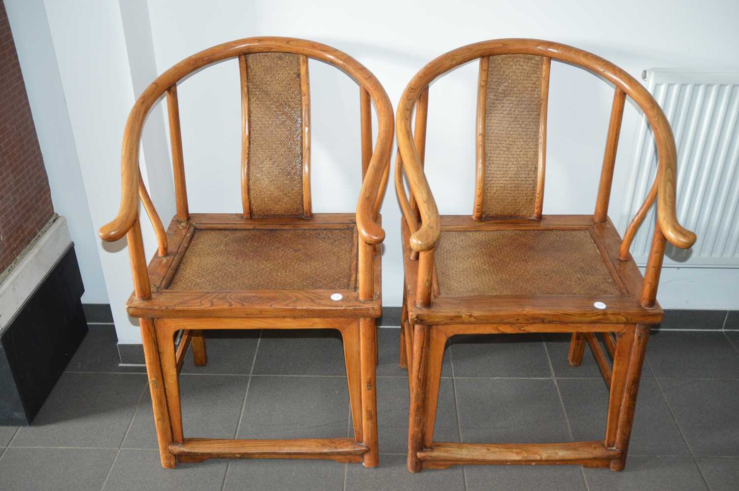 Lot 53 - A pair of late 19th century Chinese elm horseshoe back chairs
