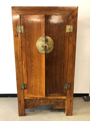 Lot 98 - A large 20th century Chinese elm and hardwood wardrobe