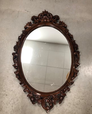 Lot 100 - An oval mahogany wall mirror