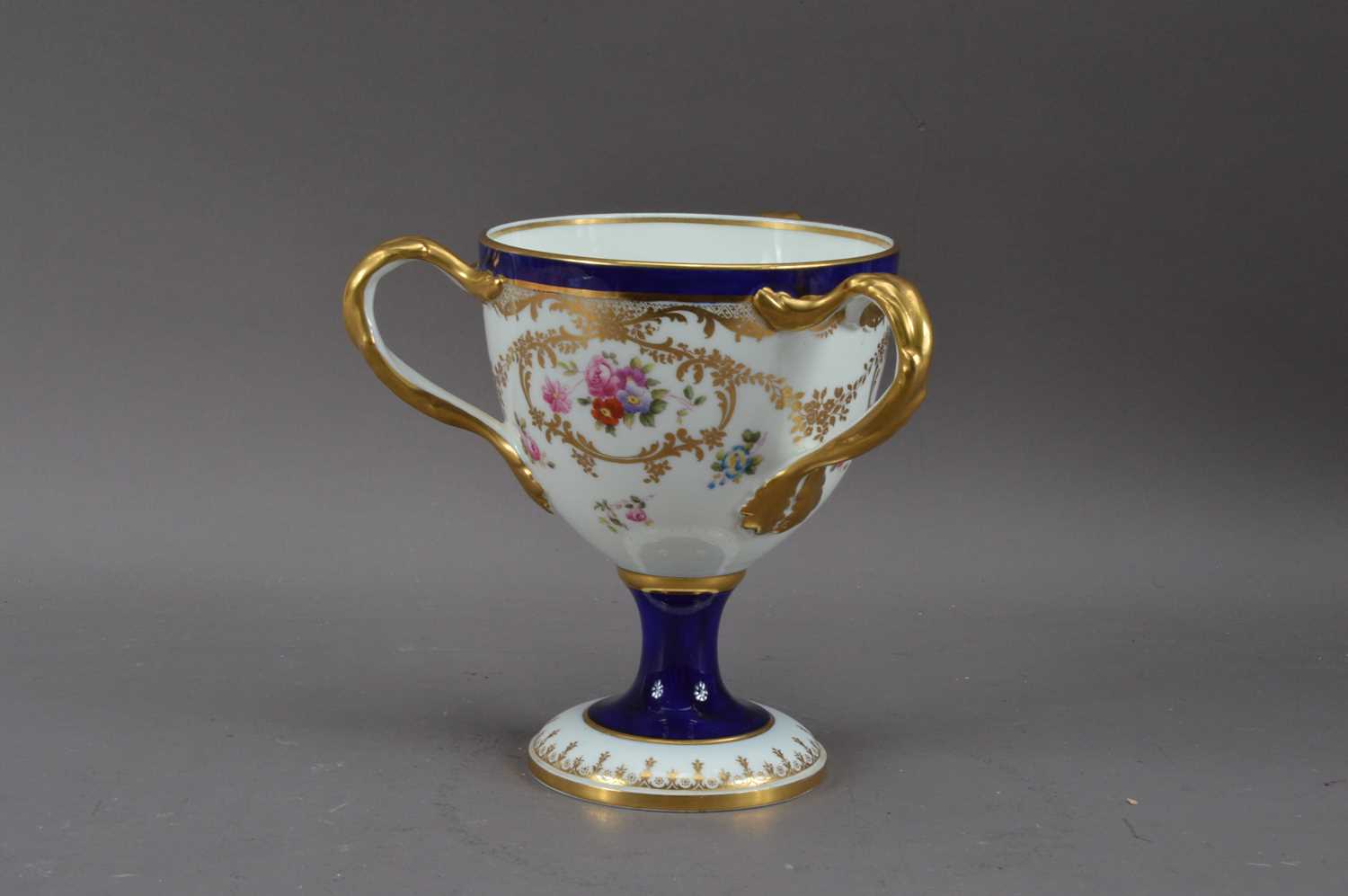 Lot 201 - A 20th century Cauldon porcelain footed tyg