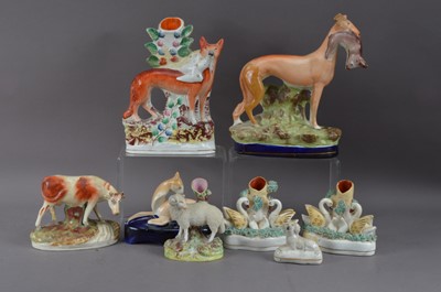 Lot 223 - A collection of 19th century Staffordshire figurines and spill vases