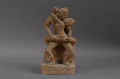 Lot 286 - A carved stone Sino-Tibetan sculpture of a couple making love