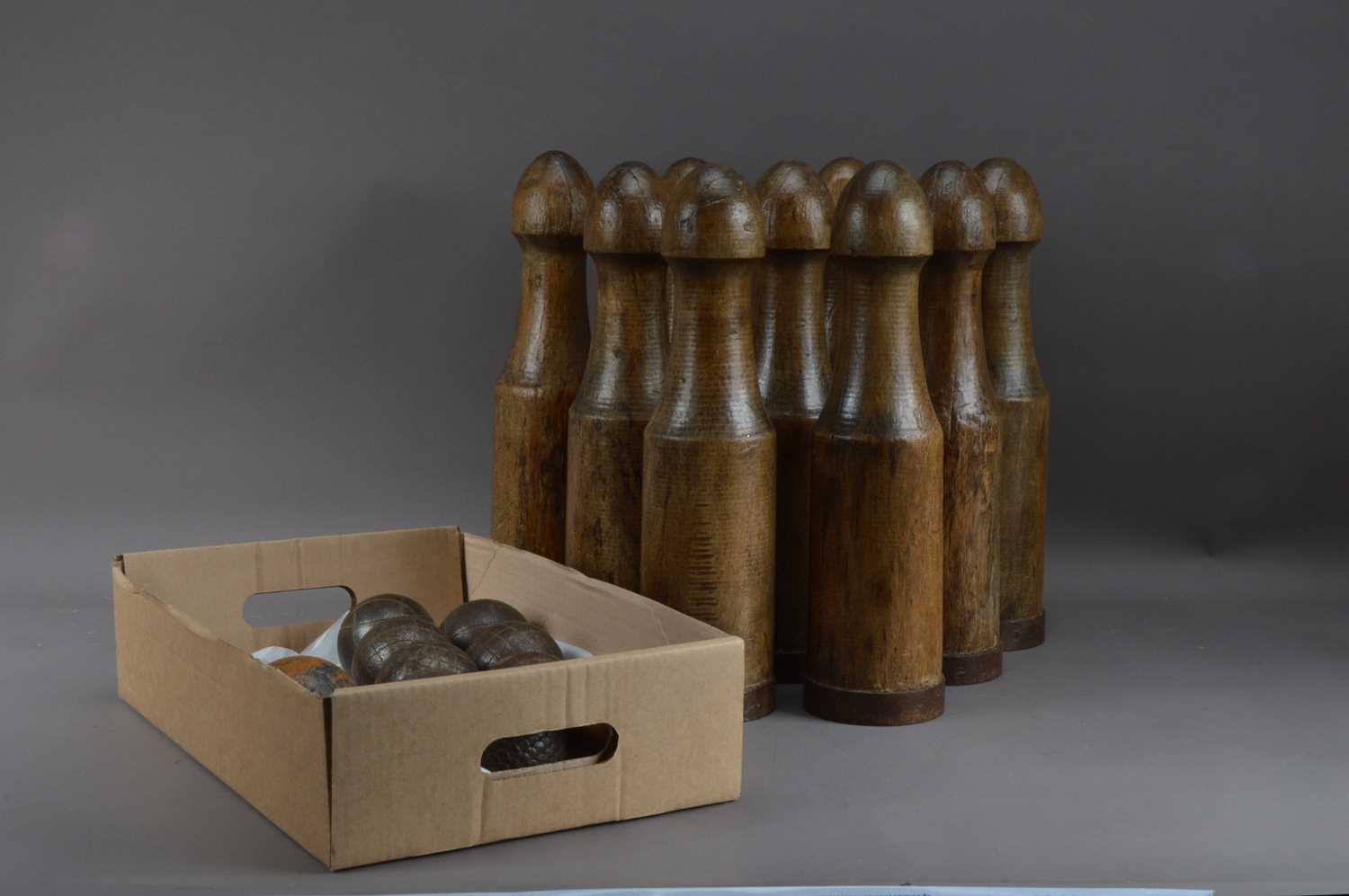 Lot 401 - A collection of nine wooden skittles