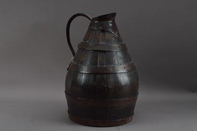 Lot 410 - An antique wood and metal bound ale jug