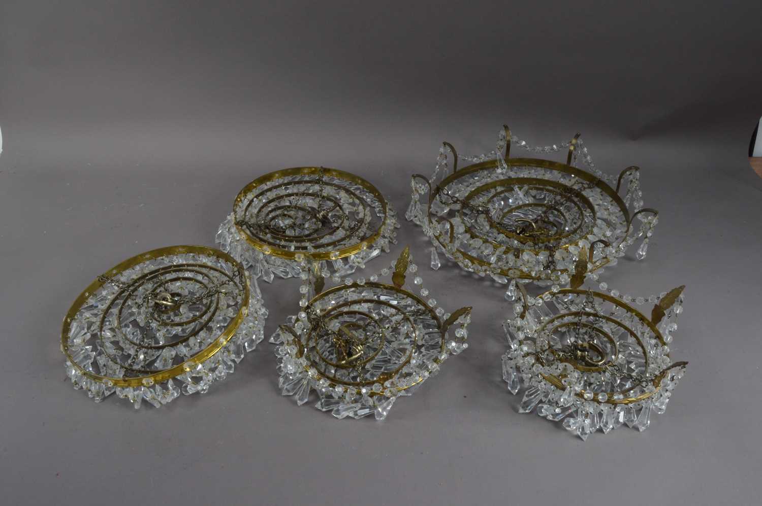 Lot 436 - Five mid to late 20th century glass dropped gilt metal chandeliers