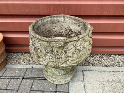 Lot 595 - A weathered concrete garden planter on stand