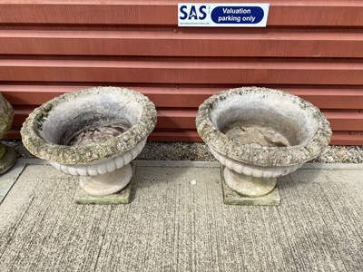 Lot 596 - A pair of weathered garden concrete planters on stands