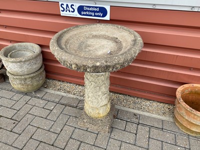 Lot 597 - A weathered associated concrete bird bath on pillar