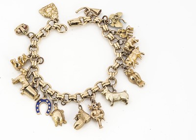 Lot 11 - A yellow metal circular linked and baton linked bracelet with yellow and 9ct gold charms