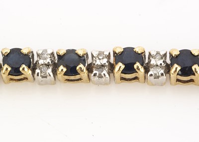 Lot 64 - A 9ct gold two colour sapphire and diamond tennis bracelet