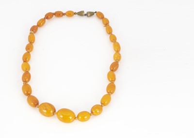 Lot 122 - A 19th Century amber oval bead graduated knotted strung necklace