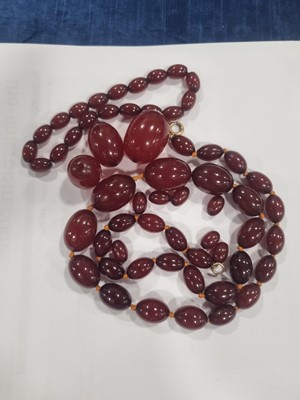 Lot 135 - A 'cherry amber' graduated knotted oval bead necklace