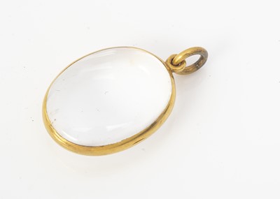 Lot 198 - A 19th century rock crystal and yellow metal oval locket