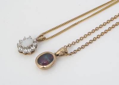 Lot 226 - Two opal set pendants
