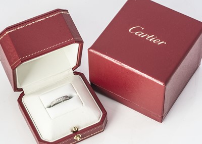 Lot 252 - A platinum and diamond Cartier cased and certificated half hoop eternity ring