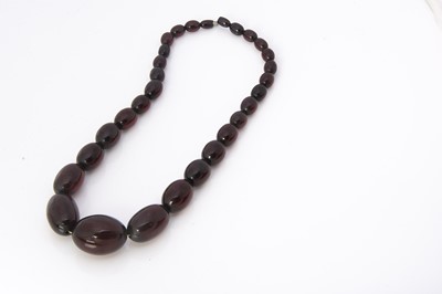 Lot 270 - A string of 'cherry amber' beads