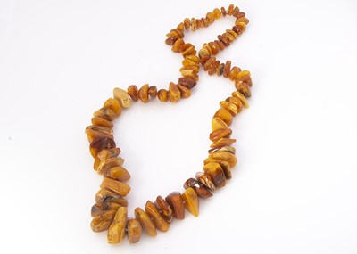 Lot 271 - A Baltic amber string of rough polished beads