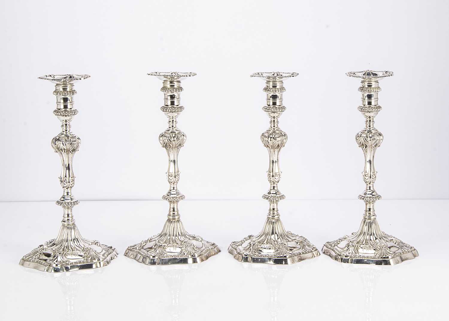 Lot 452 - A fine set of four George III cast silver candlesticks by Ebenezer Coker