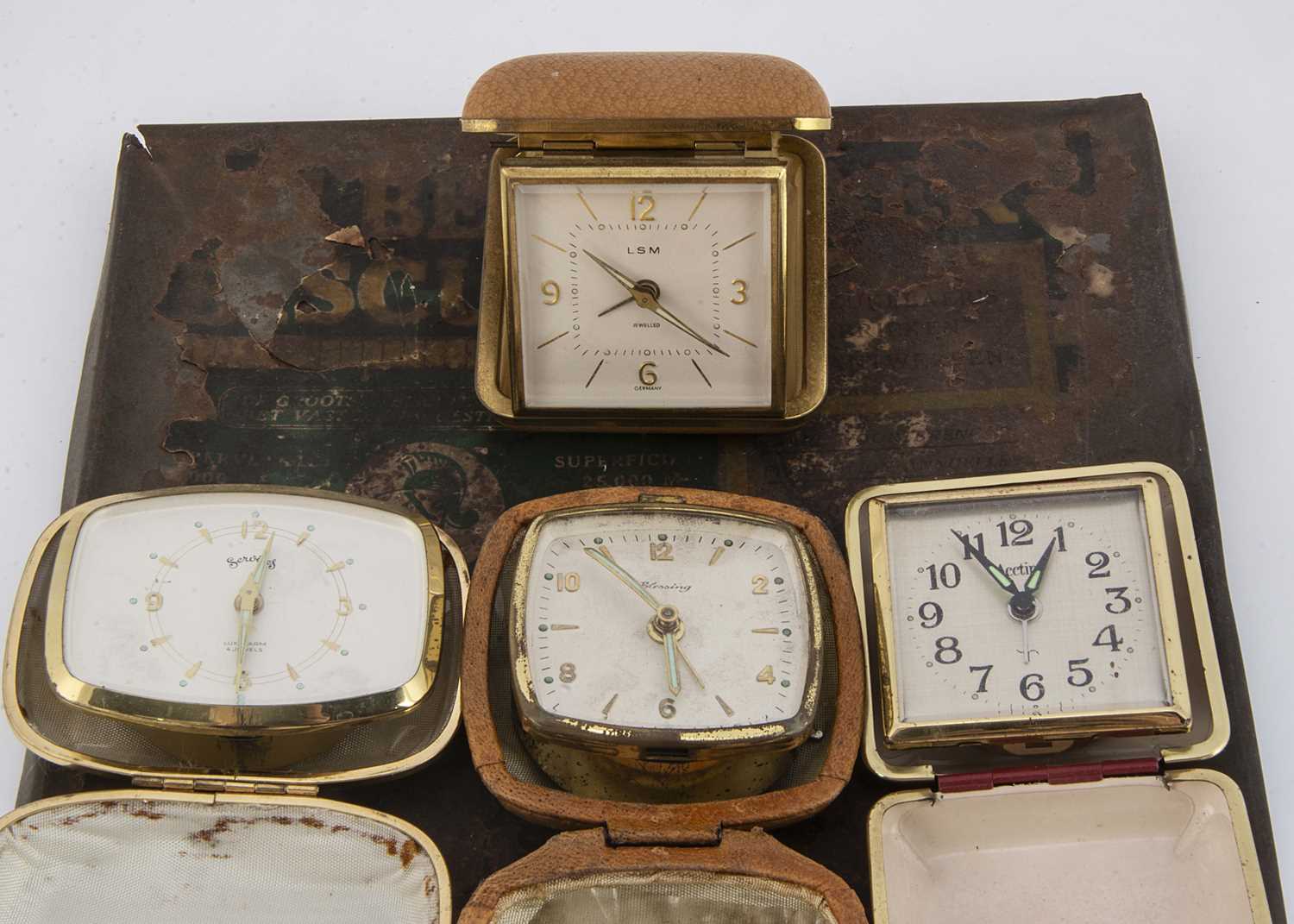 Lot 31 - Four first quarter and half 20th century travel clocks