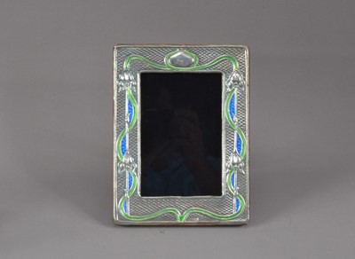 Lot 177 - A modern Arts and Crafts style silver and enamelled photograph frame