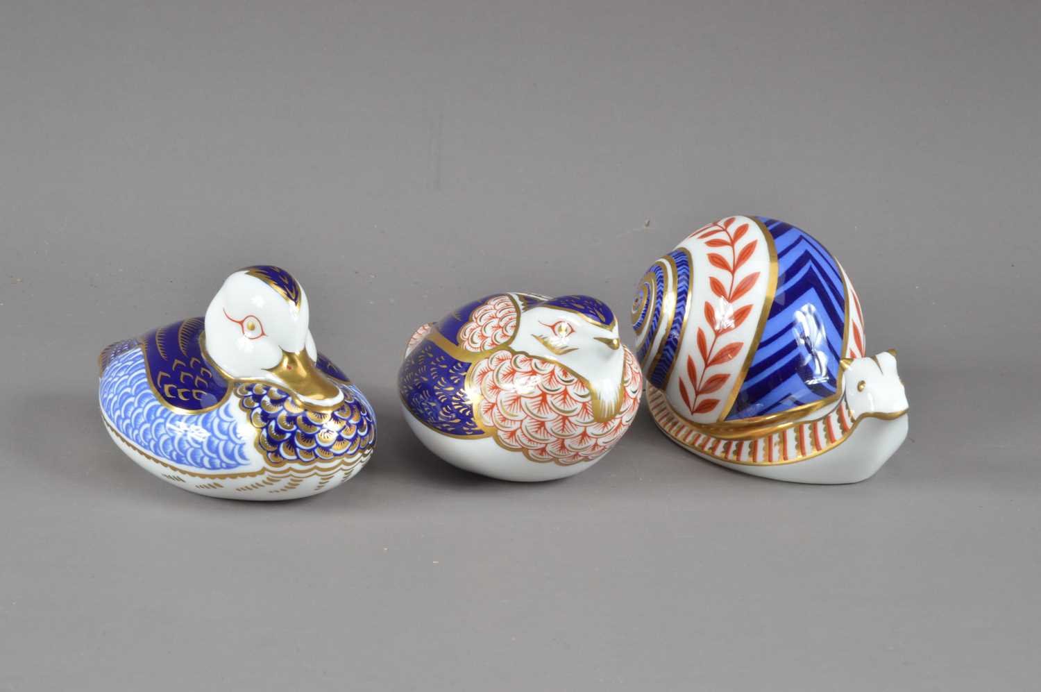 Lot 201 - Three Royal Crown Derby bone china paperweights