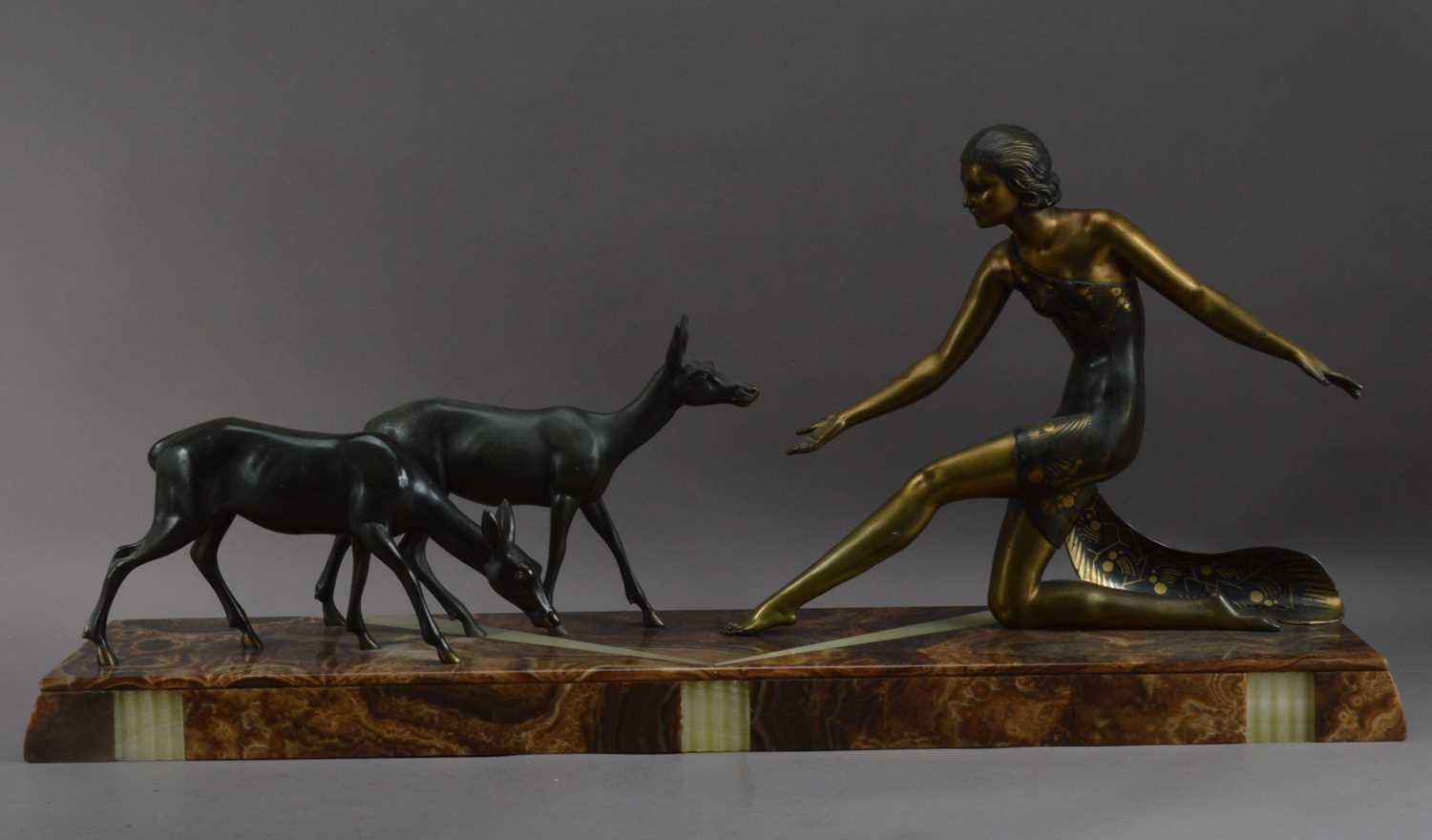Lot 314 - An art deco sculpture of a lady and two deer