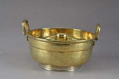 Lot 386 - A middle Eastern brass twin handled hot water tray and pierced liner