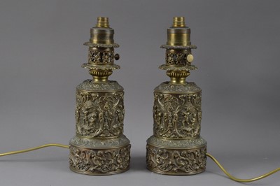 Lot 391 - A pair of decorative bronzed thin metal lamps