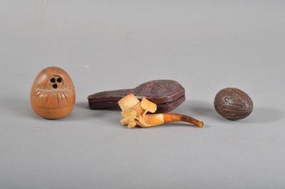 Lot 162 - A carved meerschaum pipe with an amber mouth piece