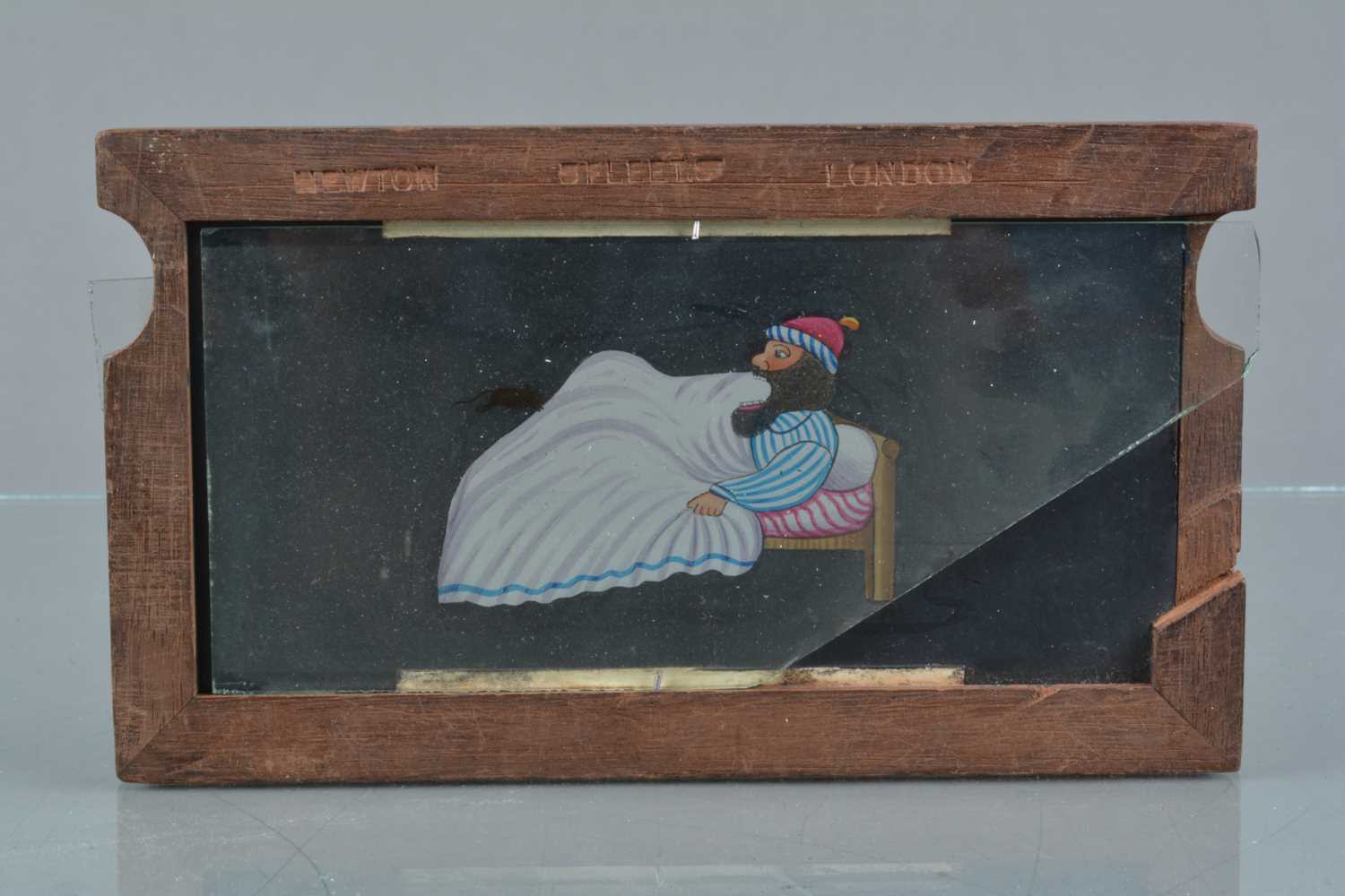 Lot 22 - A Newton & Co Mahogany-Mounted Hand-Coloured Double Slipping Magic Lantern Slide