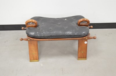 Lot 16 - A modern Middle Eastern hardwood and leather camel stool