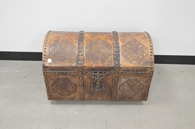 Lot 20 - A vintage African wooden and metal bound domed lidded trunk