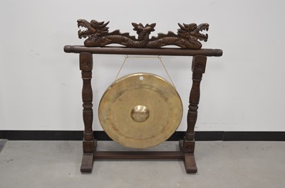 Lot 24 - A modern Chinese carved wooden and brass dinner gong