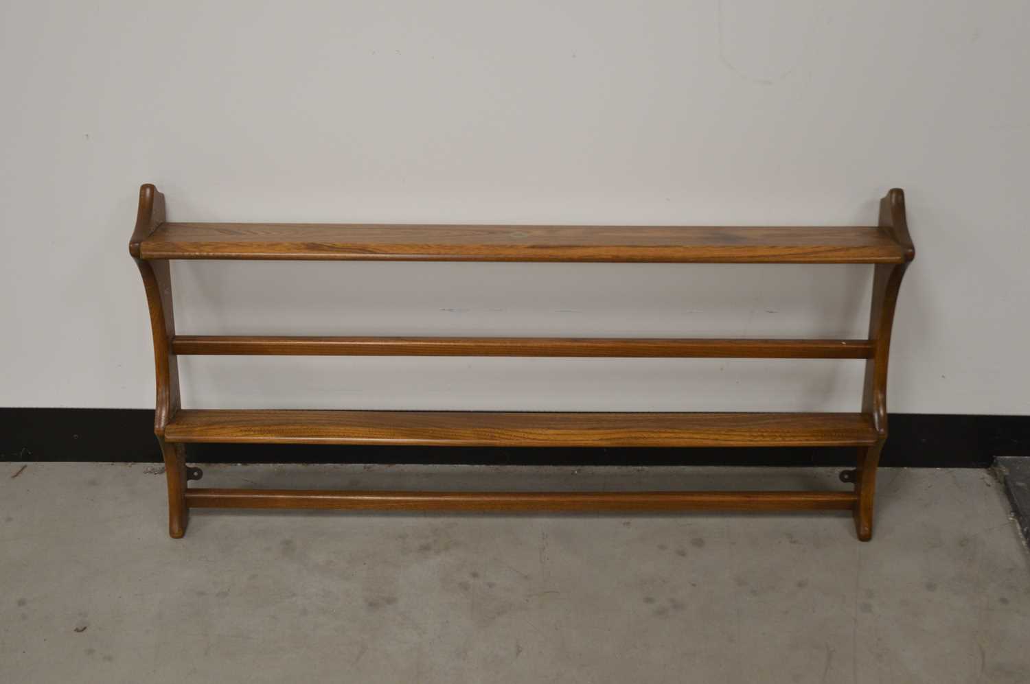 Lot 42 - A c. 1970's recoil elm rack, with two tiers, a sticker to the top, 48cm H x 96cm W