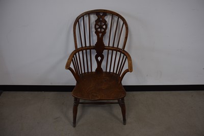 Lot 68 - An antique mixed wood wheel back chair