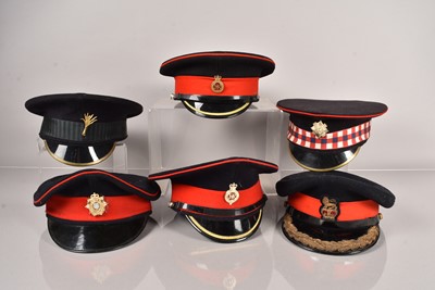 Lot 585 - A collection of Military peak caps