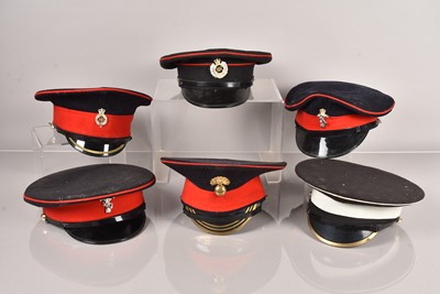 Lot 586 - A collection of Military peak caps