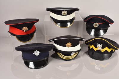 Lot 587 - A collection of Military peak caps