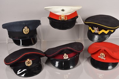 Lot 590 - A collection of Military peak caps