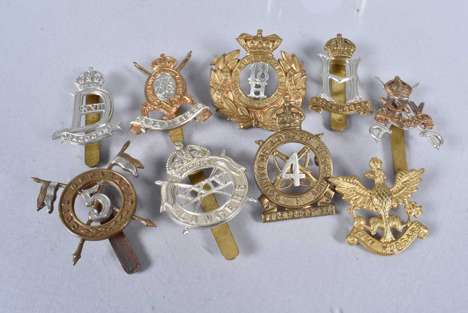 Lot 674 - An assortment of British cap badges