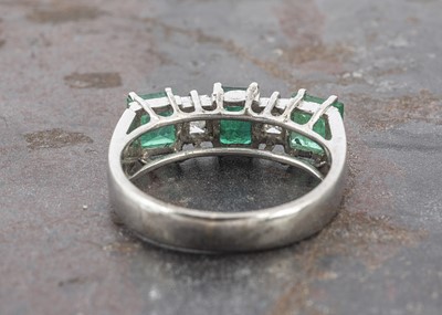 Lot 3 - A white gold emerald and white stone dress ring