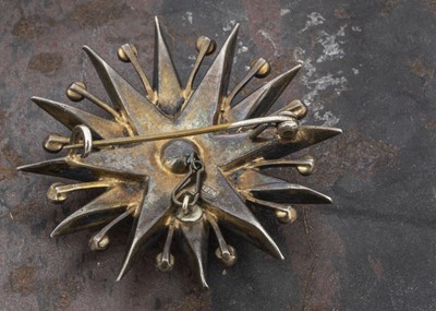 Lot 27 - An early 20th Century silver and paste set twelve point star brooch