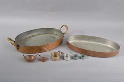Lot 197 - A small oval copper twin handled cooking pan