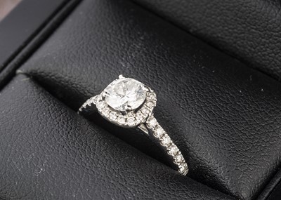 Lot 45 - An AGI certified diamond halo solitaire dress ring